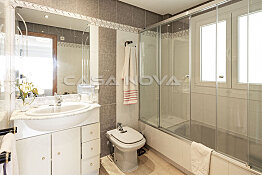 Spacious bathroom with bathtub and glass shower